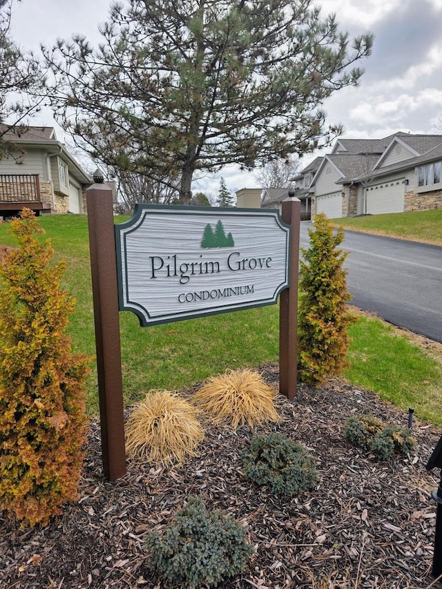 community sign featuring a garage