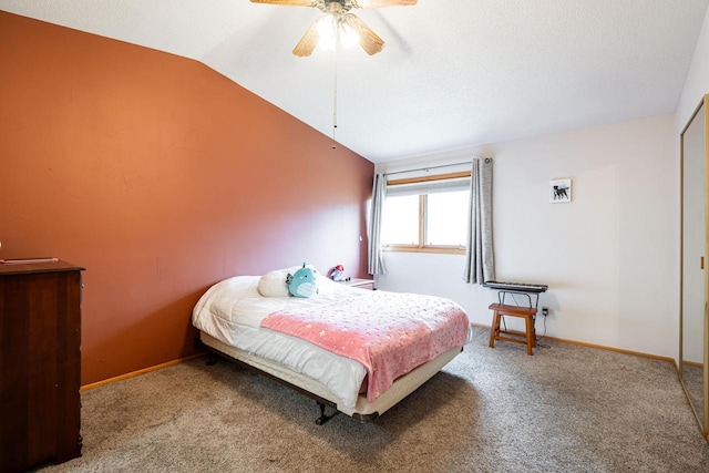carpeted bedroom with baseboards, ceiling fan, and vaulted ceiling