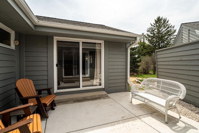 view of exterior entry with a patio