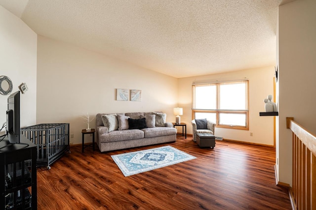 living room with baseboards, a textured ceiling, dark wood-style flooring, and lofted ceiling