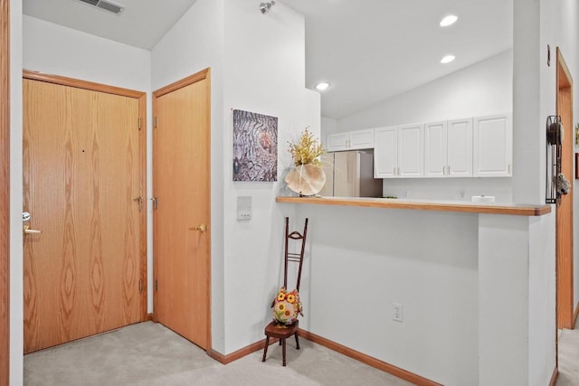 interior space featuring vaulted ceiling, light carpet, baseboards, visible vents, and recessed lighting