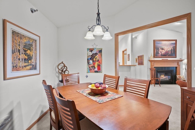 dining room featuring a fireplace with flush hearth, carpet, lofted ceiling, an inviting chandelier, and baseboards