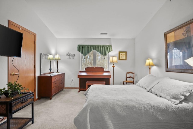 bedroom featuring baseboards, visible vents, and light colored carpet