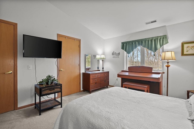 bedroom featuring light carpet, vaulted ceiling, visible vents, and baseboards