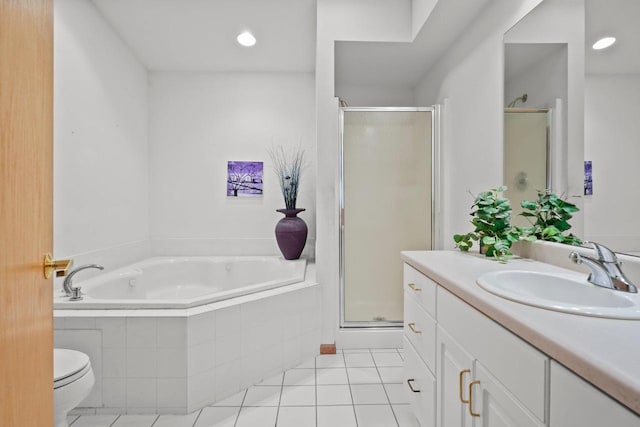bathroom featuring tile patterned floors, toilet, vanity, a garden tub, and a stall shower