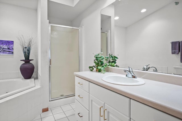 full bathroom featuring a tub with jets, vanity, tile patterned floors, and a stall shower