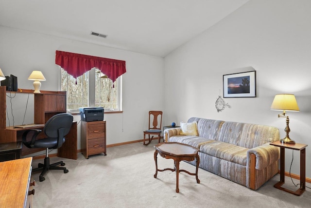office featuring vaulted ceiling, visible vents, carpet flooring, and baseboards