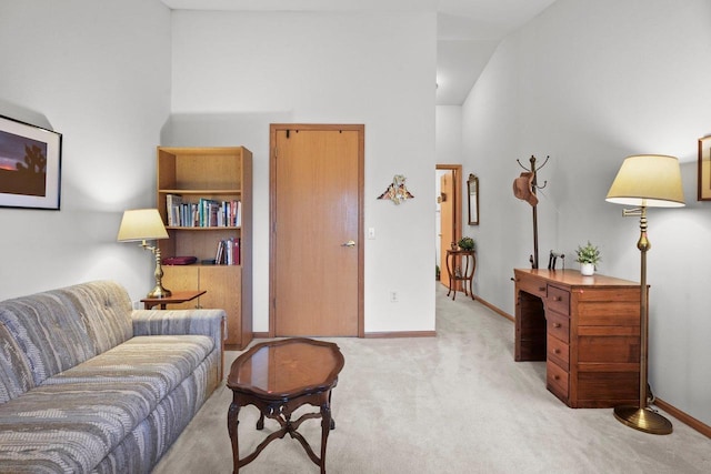living room with light colored carpet, baseboards, and high vaulted ceiling