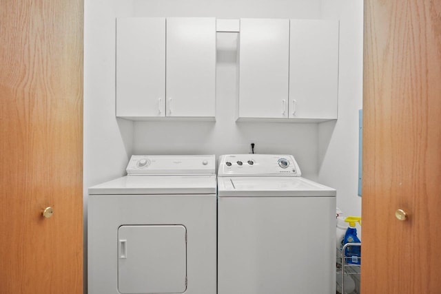 clothes washing area with cabinet space and washer and clothes dryer