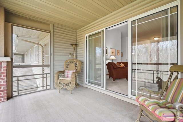 sunroom featuring carpet and wooden ceiling