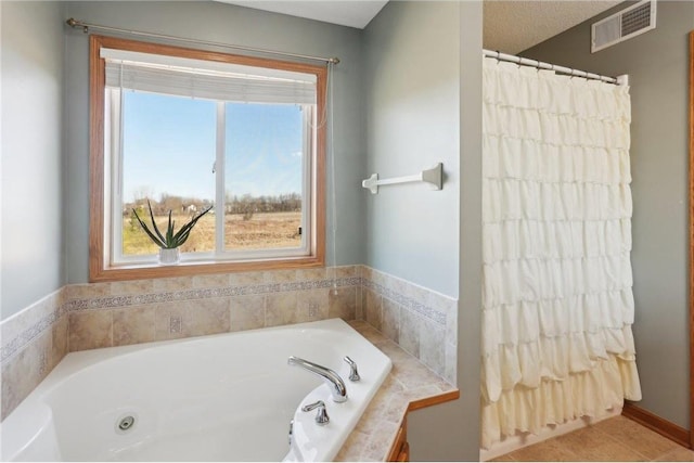 bathroom with a bath and visible vents