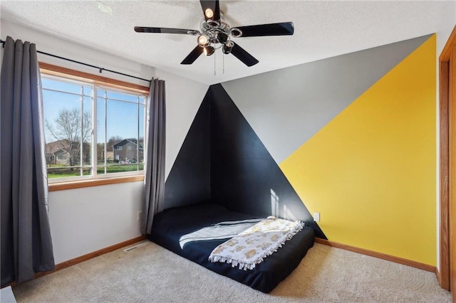 bedroom featuring a ceiling fan, a textured ceiling, vaulted ceiling, baseboards, and carpet flooring