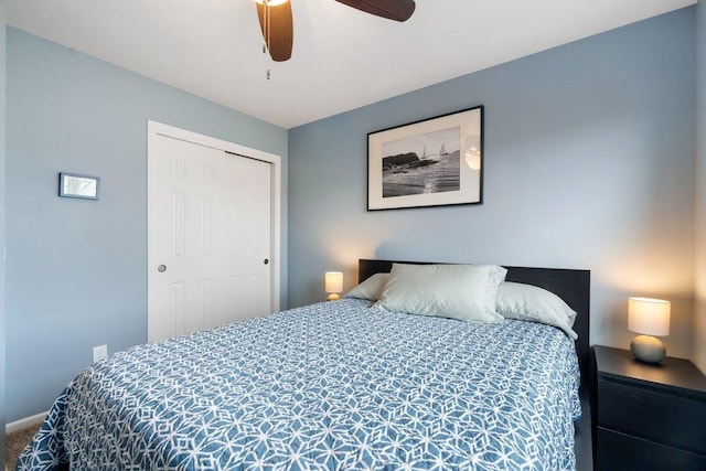 carpeted bedroom featuring a ceiling fan and a closet