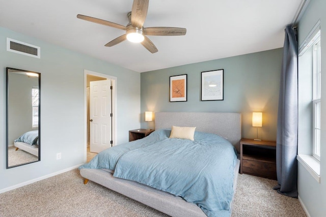 bedroom with visible vents, carpet flooring, baseboards, and a ceiling fan