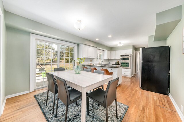 dining area featuring recessed lighting, baseboards, and light wood-type flooring