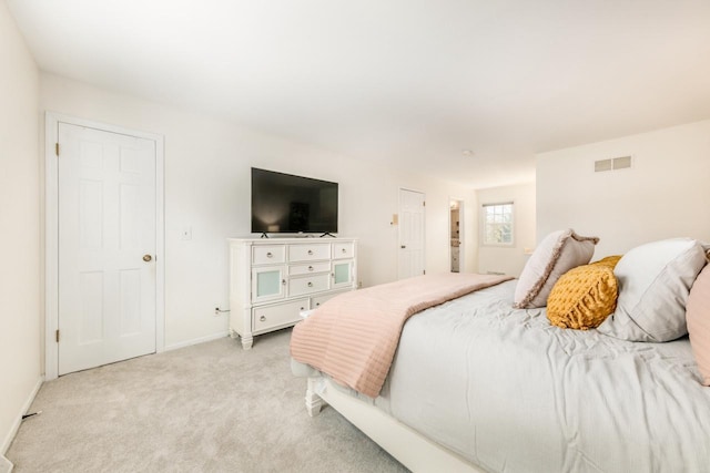 bedroom with light carpet, visible vents, and baseboards