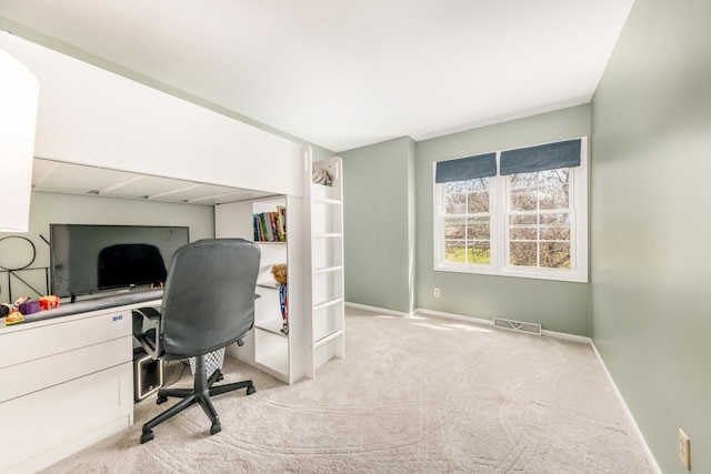 home office with carpet floors, visible vents, and baseboards