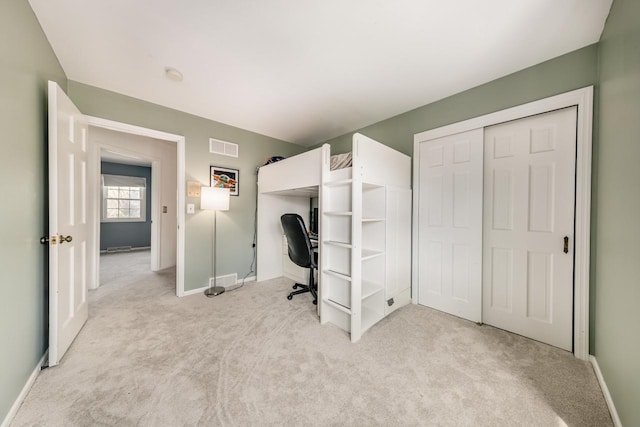 unfurnished office featuring baseboards, visible vents, and carpet
