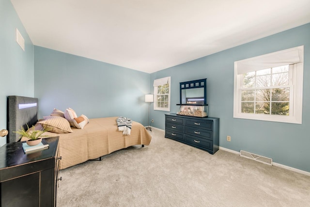 carpeted bedroom with baseboards and visible vents