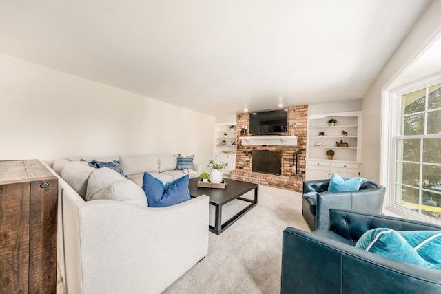 living room with a fireplace, built in shelves, and light colored carpet