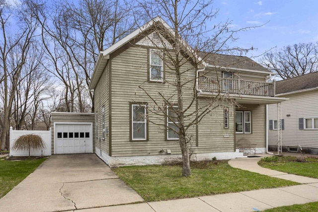526 N Vine St, Appleton, WI 54911 - view of front facade featuring concrete driveway, a front yard, a balcony, and a garage