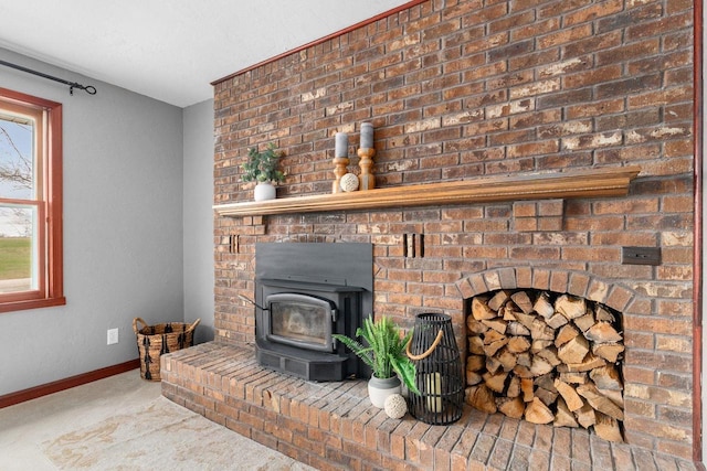 carpeted living area with baseboards and a wood stove