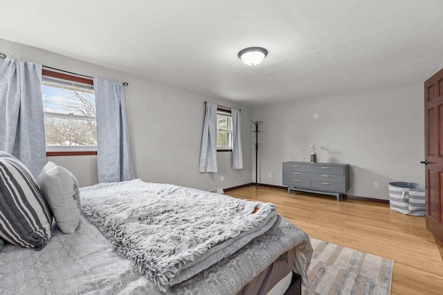 bedroom with baseboards and light wood-style floors