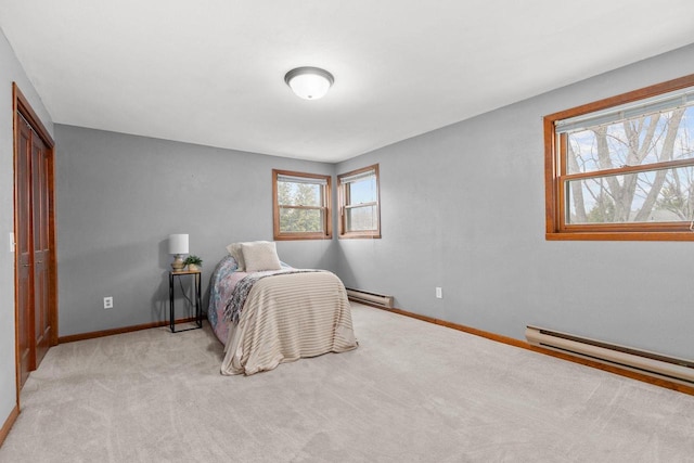 carpeted bedroom featuring baseboard heating and baseboards