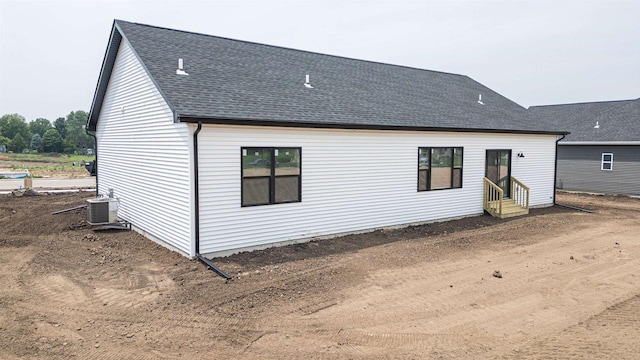 898 Red Hawk Dr, Milton, WI 53563 - rear view of house featuring entry steps, roof with shingles, and cooling unit