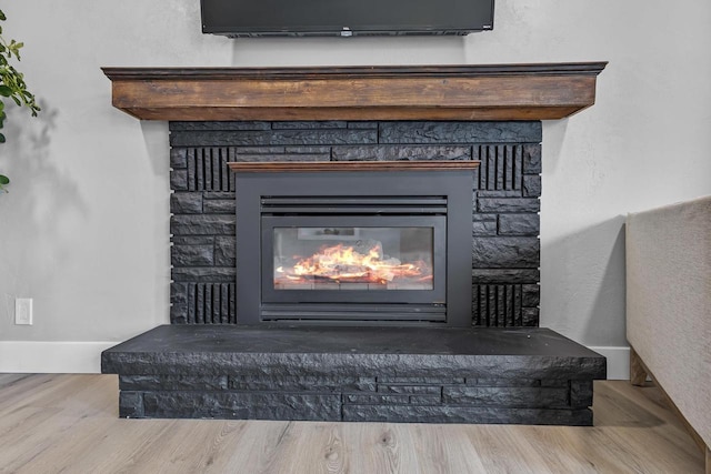 room details with wood finished floors and a fireplace