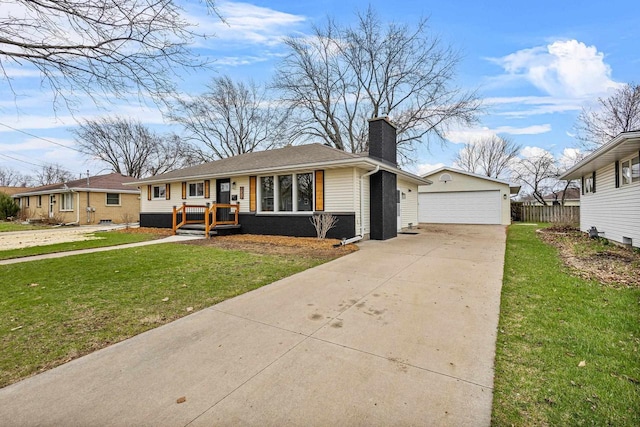 view of front of house featuring a front lawn, a chimney, an outdoor structure, and a detached garage