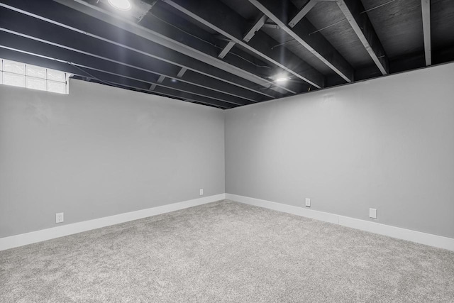 basement featuring baseboards and carpet floors