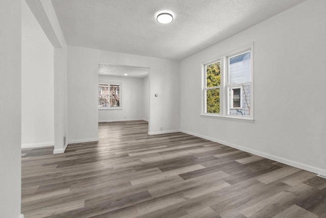 76 E Johnson St, Fond Du Lac, WI 54935 - empty room with baseboards, wood finished floors, and a textured ceiling