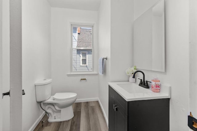 76 E Johnson St, Fond Du Lac, WI 54935 - half bath with toilet, vanity, wood finished floors, and baseboards