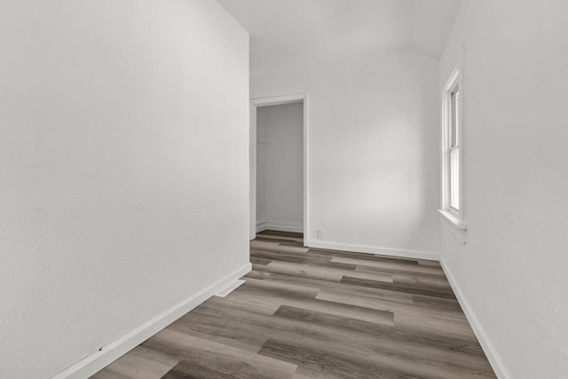 76 E Johnson St, Fond Du Lac, WI 54935 - empty room featuring lofted ceiling, wood finished floors, and baseboards