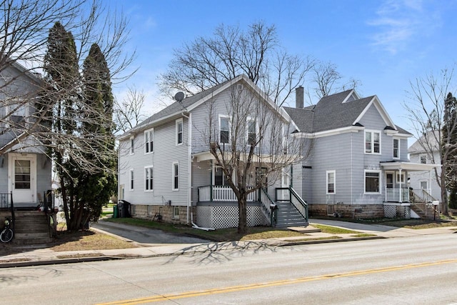 76 E Johnson St, Fond Du Lac, WI 54935 - view of front of home featuring a chimney and covered porch