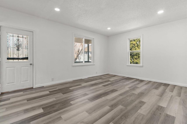 76 E Johnson St, Fond Du Lac, WI 54935 - empty room featuring wood finished floors, a textured ceiling, and recessed lighting