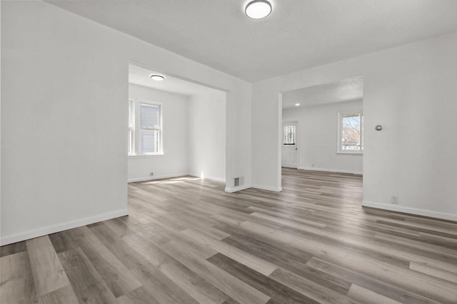76 E Johnson St, Fond Du Lac, WI 54935 - empty room featuring wood finished floors, visible vents, and baseboards