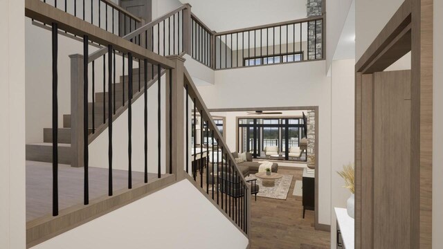 W2600 Oakwood Beach Rd, Markesan, WI 53946 - stairs with a towering ceiling, wood finished floors, and a ceiling fan
