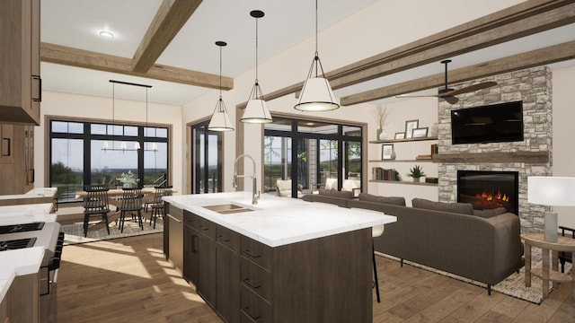 W2600 Oakwood Beach Rd, Markesan, WI 53946 - kitchen featuring a sink, beam ceiling, ceiling fan, dark brown cabinets, and open floor plan