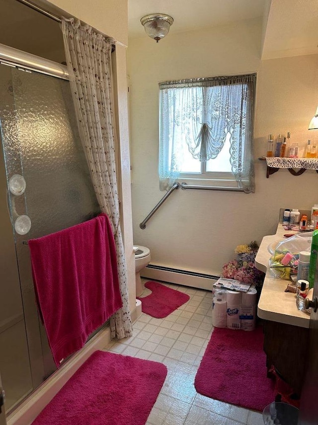 bathroom featuring tile patterned floors, vanity, a shower stall, and a baseboard radiator