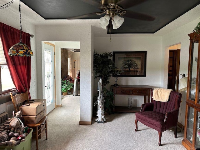 sitting room with carpet floors, ceiling fan, and a healthy amount of sunlight