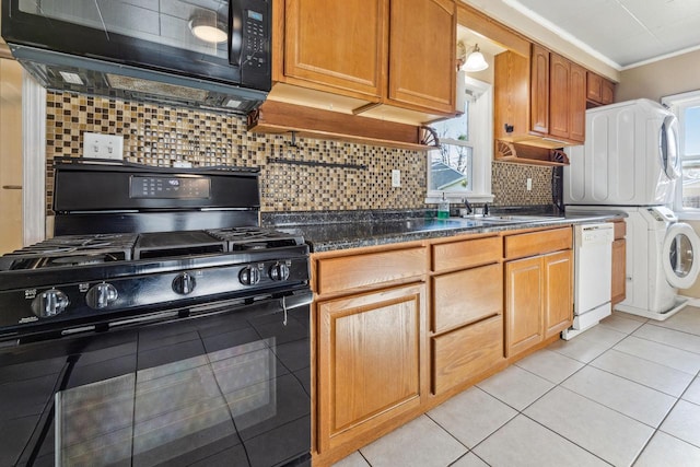 1931 Wood St, La Crosse, WI 54603 - kitchen featuring plenty of natural light, stacked washer and clothes dryer, a sink, and black appliances