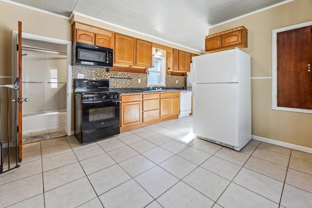 1931 Wood St, La Crosse, WI 54603 - kitchen featuring dark countertops, light tile patterned floors, crown molding, decorative backsplash, and black appliances
