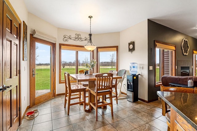 dining space featuring baseboards and light tile patterned flooring