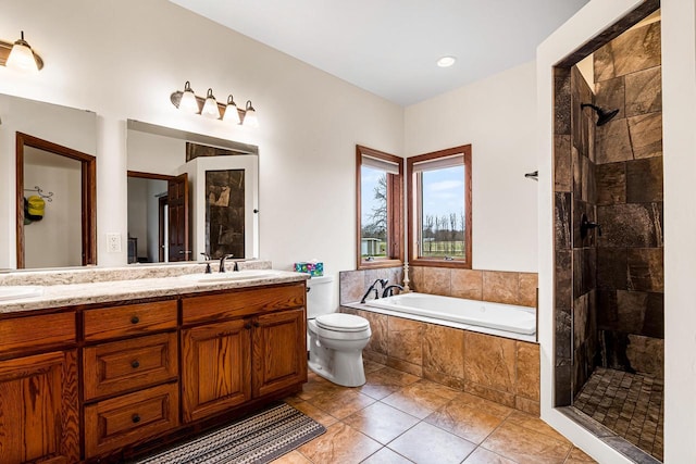 bathroom with a garden tub, a sink, double vanity, and tiled shower