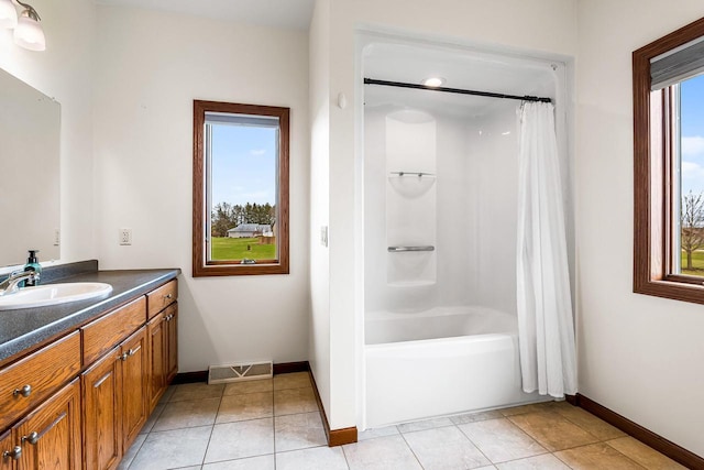 full bathroom featuring shower / tub combo, baseboards, tile patterned flooring, and vanity