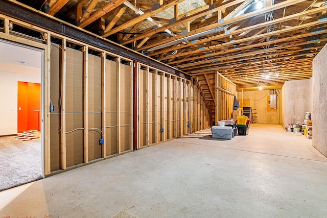 unfinished basement featuring electric panel