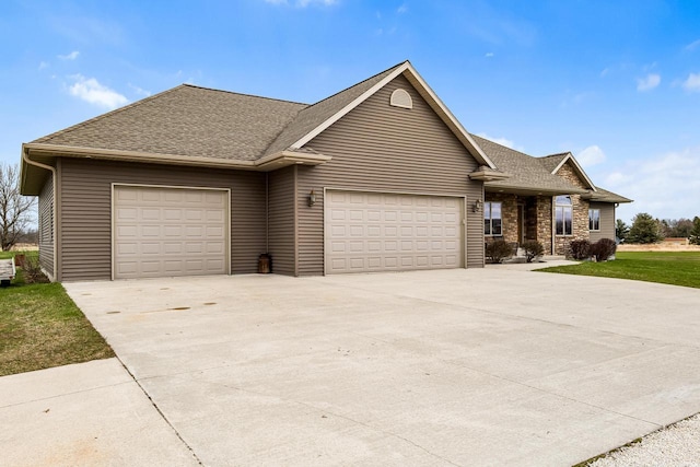 ranch-style home featuring an attached garage, driveway, and a shingled roof