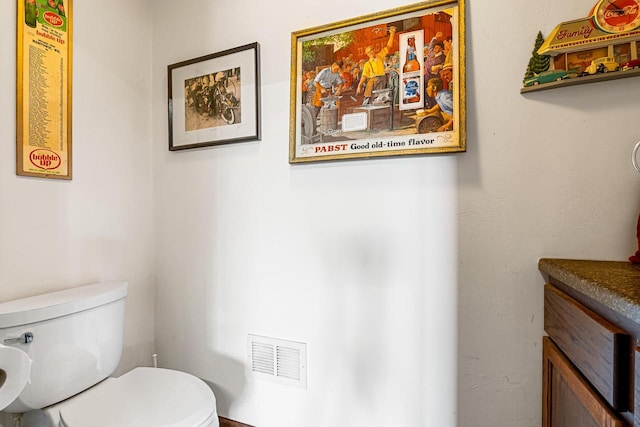 bathroom with visible vents and toilet